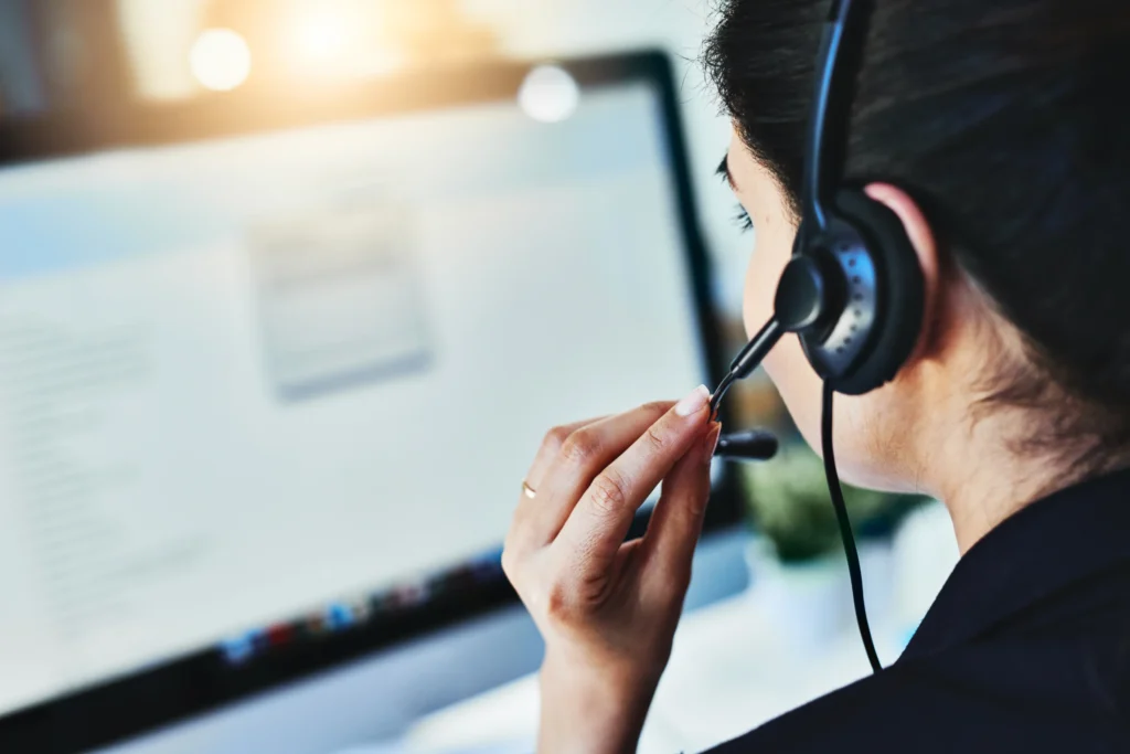 woman speaking to ear piece in her telephone answering business