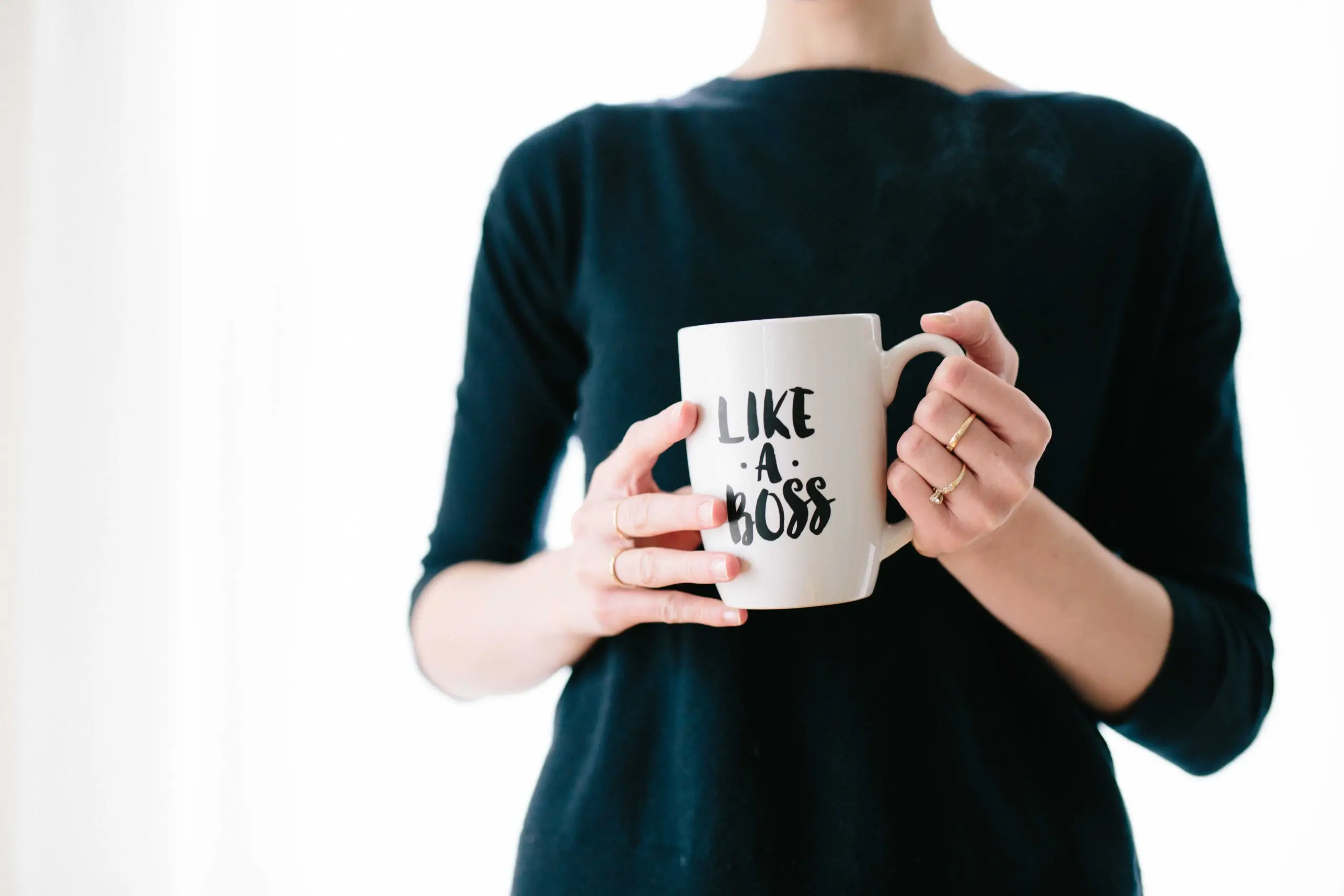 small business ideas: woman entrepreneur holding a mug