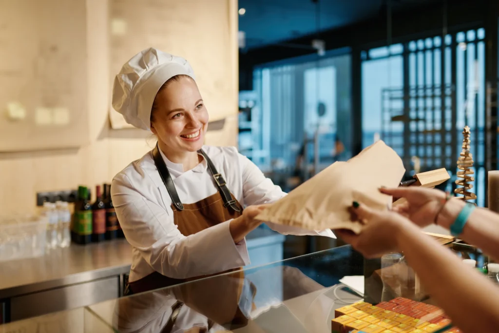 woman baker selling baked goods from her bakery