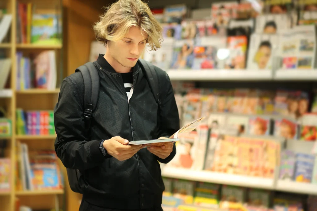 young man at an anime, manga and comic shop